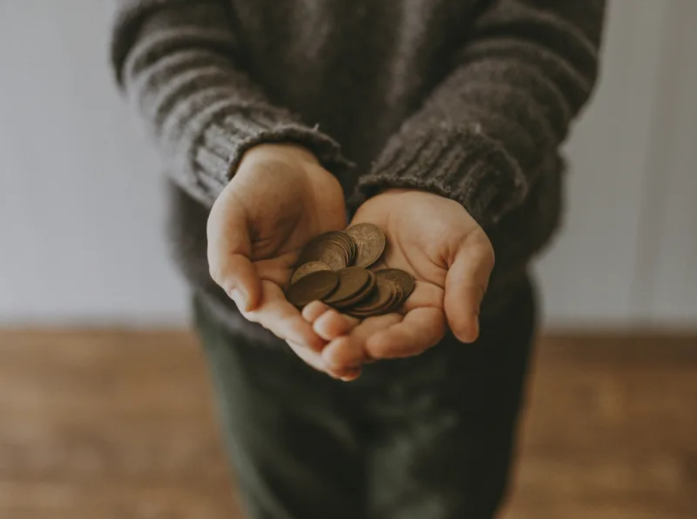 Hands holding coins